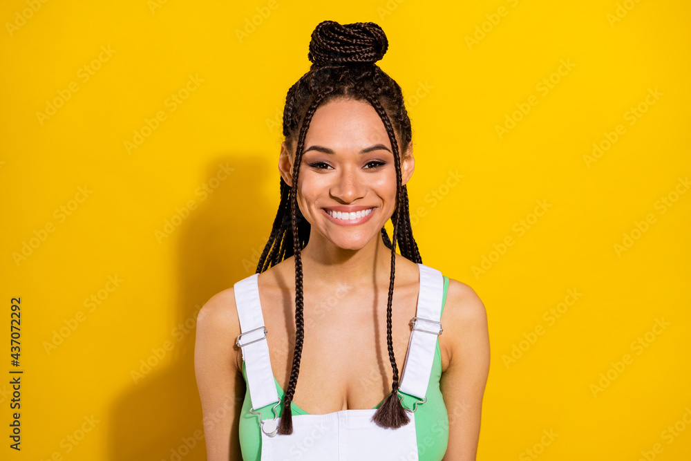Photo of cute adorable dark skin lady wear green crop top smiling isolated yellow color background Photo of cute adorable dark skin lady wear green crop top smiling isolated yellow color background