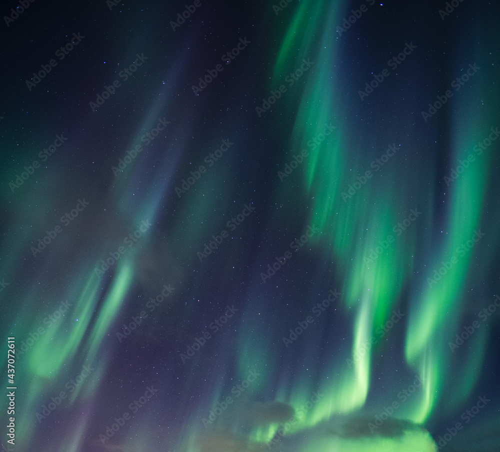 Aurora borealis, Northern lights with stars glowing in the night sky