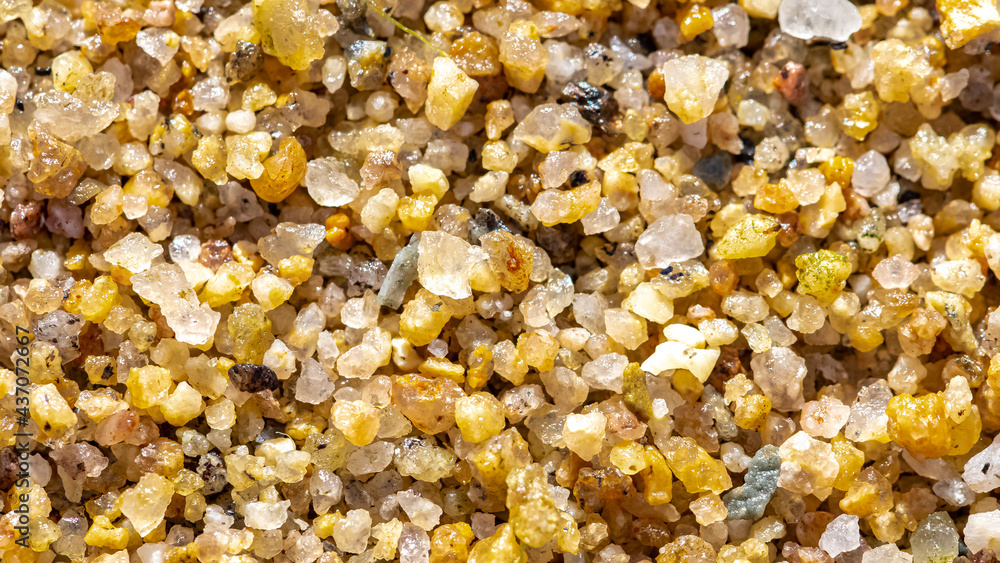 Small grains of sand on a beach, colorful background
Small grains of sand on a beach, colorful background