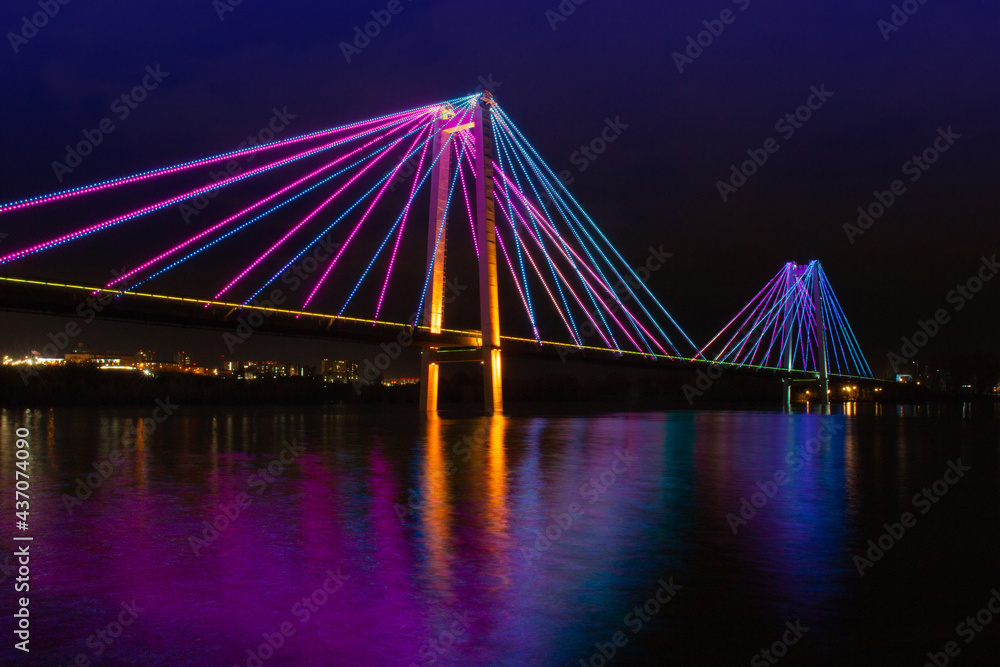 Artistic night view on colorful illuminated of suspension bridge in Krasnoyarsk, Russia