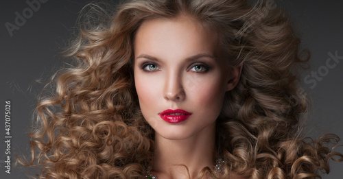 Beautiful woman with magnificent curly hair. Red lipstick.
