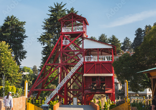 Ancient mining structure in the shape of a tower with its characteristic red color, now used as a tourist place in the Magical Town of El Oro, State of Mexico.