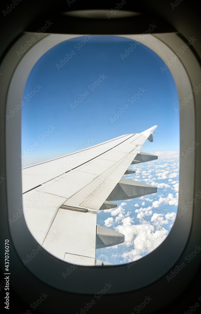 view to the wing and clouds from the plane view to the wing and clouds from the plane