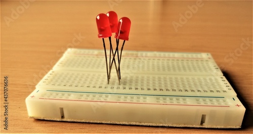 Принти на полотні Red colored LED lights on a breadboard for conducting electronics experiments fo