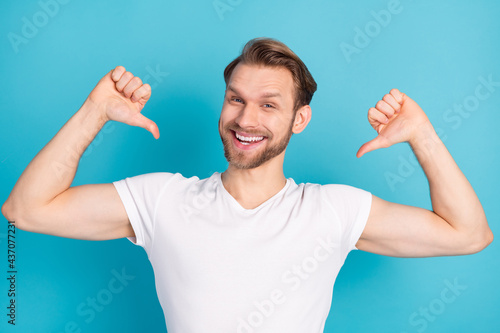 Photo of satisfied young person toothy smile indicate thumbs in self look camera isolated on blue color background