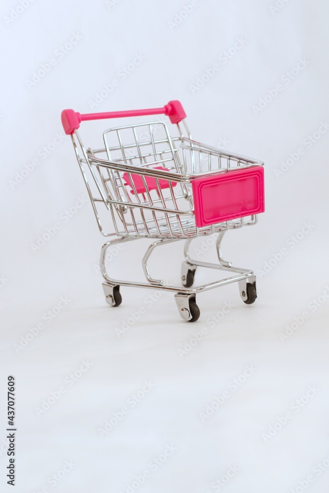 Mini shopping cart or trolley isolated on white background with copy space.