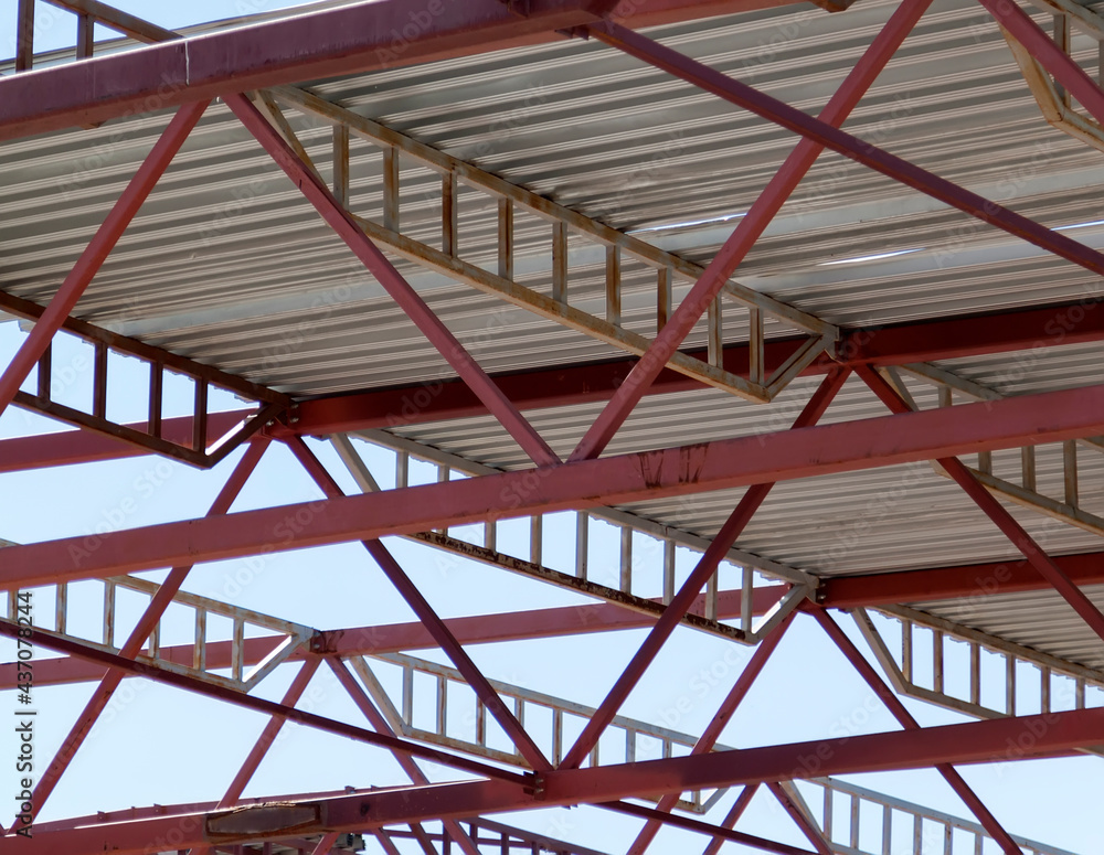 Metal beams at top of structure of building under construction. steel roof frame workshop