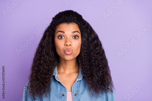 Photo of flirty sweet dark skin lady wear denim shirt sending you kiss isolated purple color background