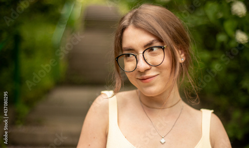 dreamy girl with glasses in the park portrait