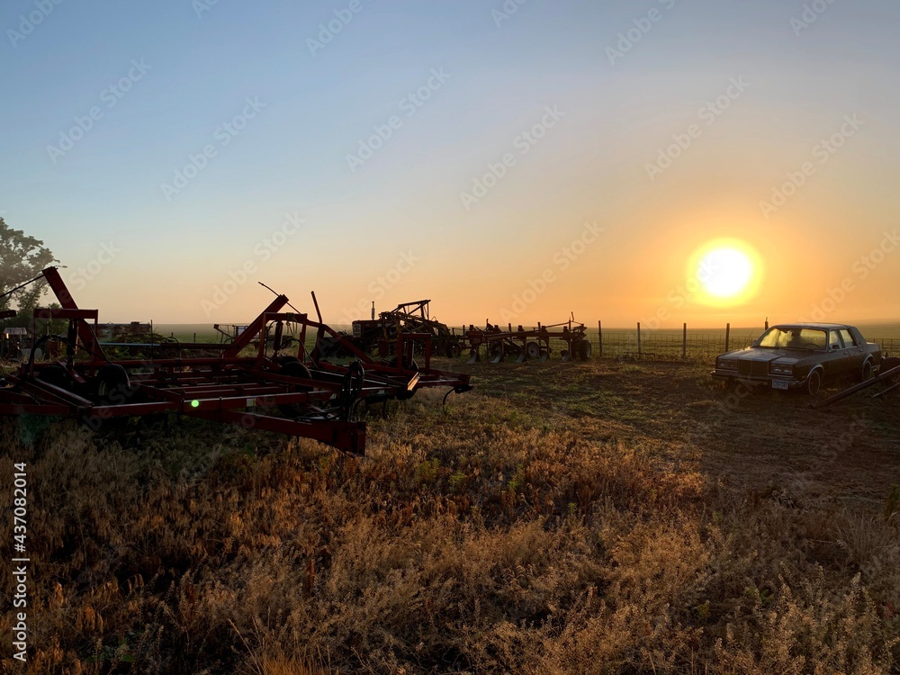 Fototapeta premium farm equipment sunrise