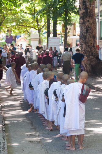 Young monks standing in line for rice lunch at the Mahagandayon Monastery