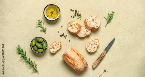 Wallpaper Mural Fresh Italian ciabatta bread with olive oil, olives and rosemary on a beige concrete background. Top view, flat lay. Banner Torontodigital.ca
