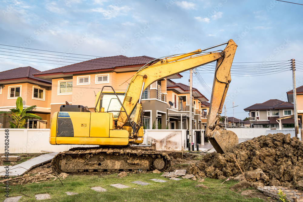 Backhoe excavator at house construction site Backhoe excavator at house construction site