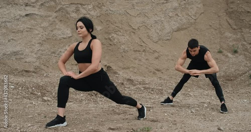 Two Athletes in Black Sportswear Training Together and Doing Stretching Open Air, Healthy Lifestyle and Outdoors Workout