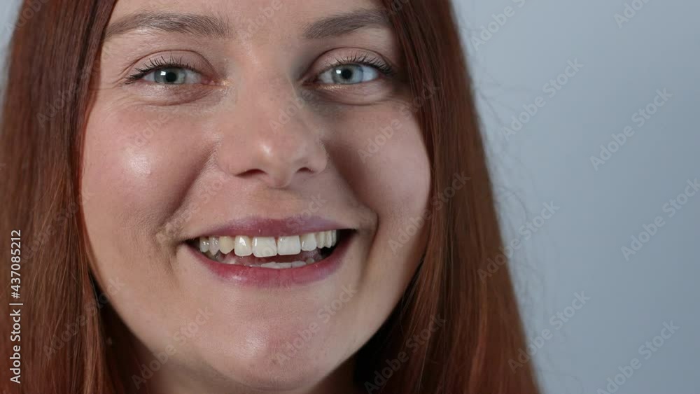 Close up of joyful charming caucasian woman biting yellow ripe banana and looking into camera. Female face eating banana Close up of joyful charming caucasian woman biting yellow ripe banana and looking into camera. Female face eating banana