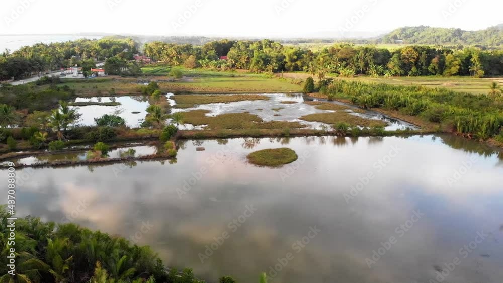 Sundown over fish farm ponds, Philippines Sundown over fish farm ponds, Philippines