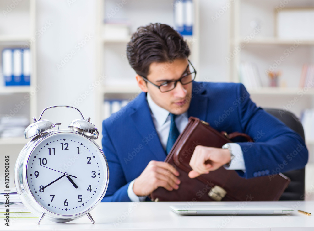 Businessman in bad time management concept Businessman in bad time management concept