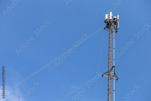 transmitter atop a cell phone pole About to be upgraded from 4g to 5g. High-risk electrical engineer job in Thailand.