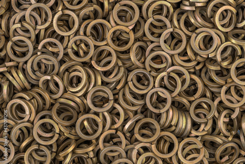 Brass color steel grover washers for industrial manufacturing. Texture background of grover washers.