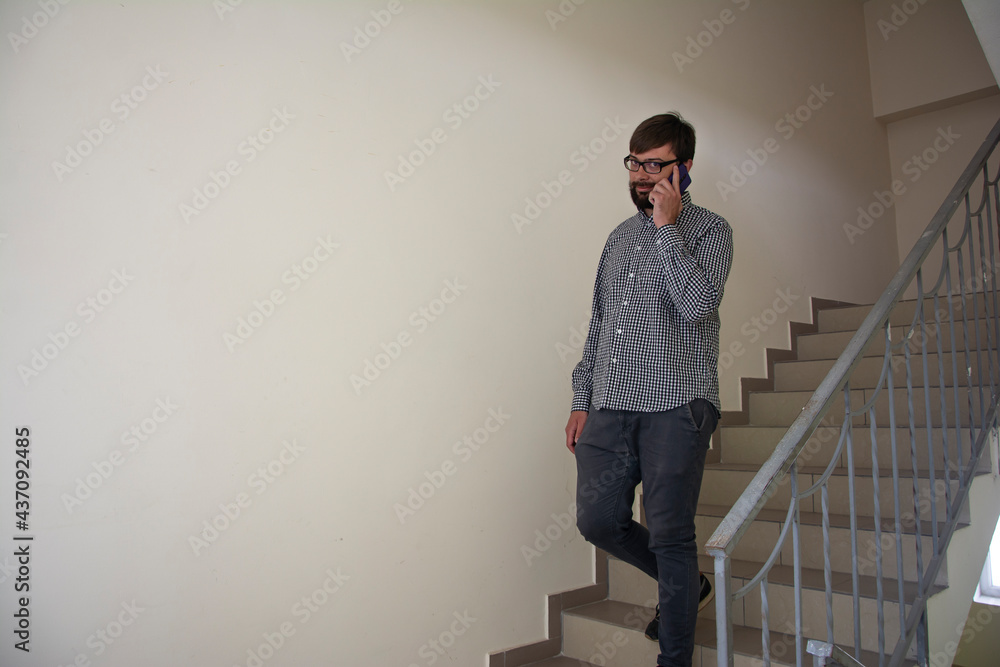 Close-up portrait of a young handsome smiling positive business man who speaks on the phone Close-up portrait of a young handsome smiling positive business man who speaks on the phone