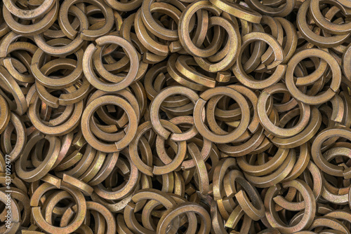 Brass color steel grover washers for industrial manufacturing. Texture background of grover washers.