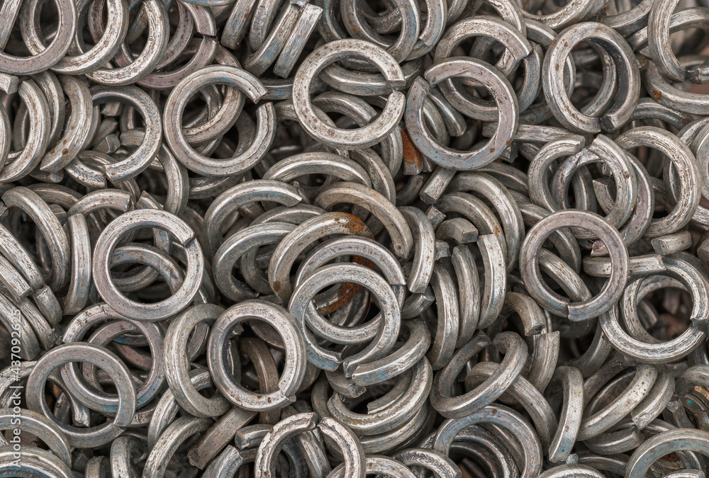Steel grover washers for industrial manufacturing. Texture background of grover washers.