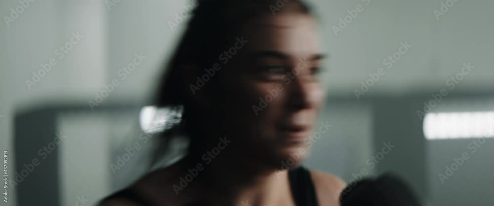 EXTREME CU Portrait of Caucasian female boxer practicing punches with her coach on a boxing ring. Shot with 2x anamorphic lens EXTREME CU Portrait of Caucasian female boxer practicing punches with her coach on a boxing ring. Shot with 2x anamorphic lens