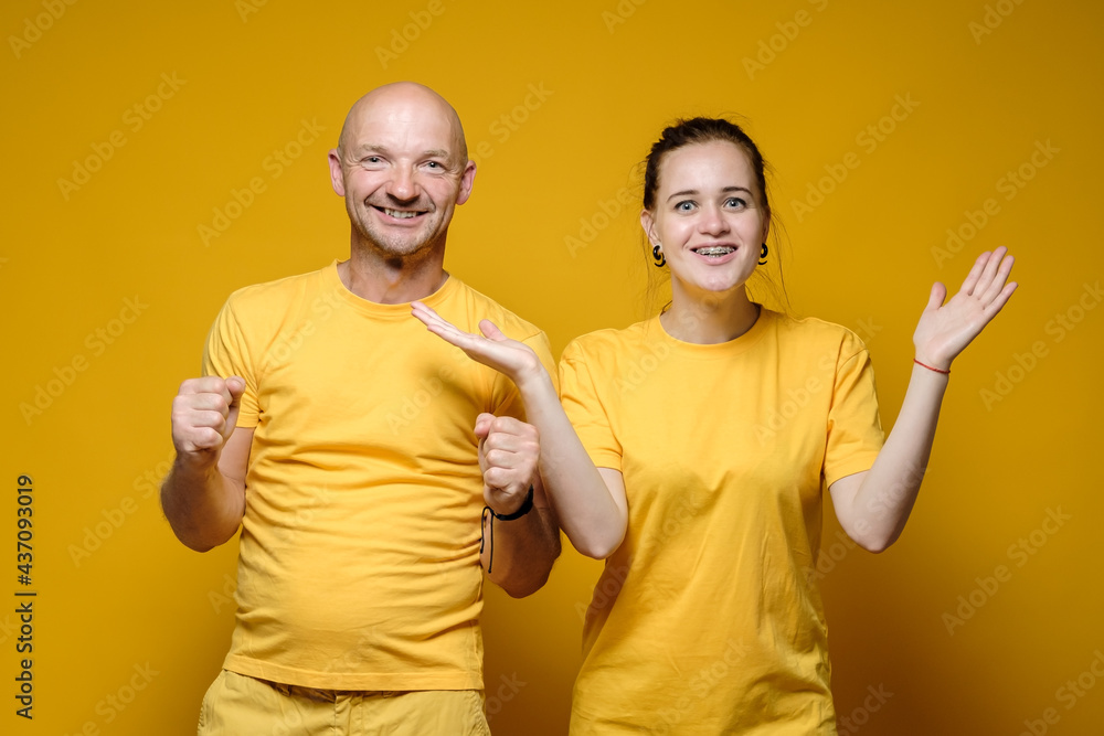 Satisfied, smiling man and woman, in anticipation of a miracle and a pleasant surprise, look at the camera with bated breath. Satisfied, smiling man and woman, in anticipation of a miracle and a pleasant surprise, look at the camera with bated breath.