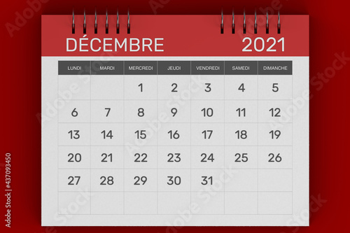 3d rendering of Business monthly calendar in French with metal spiral-bound, the week starts on Monday. Monthly Pages with red title, isolated on red background. French calendar for December 2021