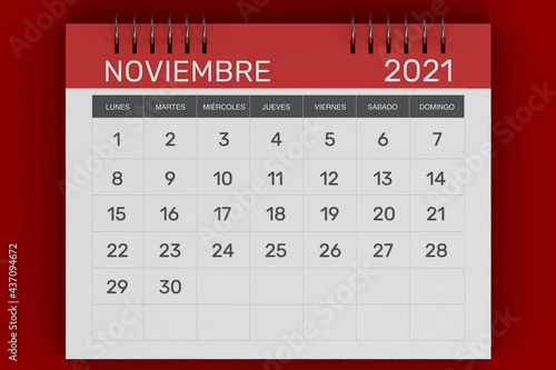 3d rendering of Business monthly calendar in Spanish with metal spiral-bound, the week starts on Monday. Monthly Pages with red title, isolated on red background. Spanish calendar for November 2021 photo