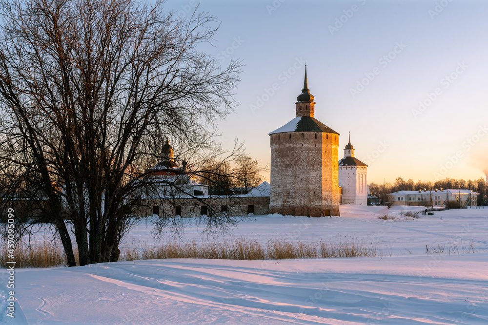 View of the Kuznechnaya Tower of the Kirilo-Belozersky Monastery from Lake Siversky on a frosty winter morning in the rays of the rising sun, Kirillov, Vologda region, Russia