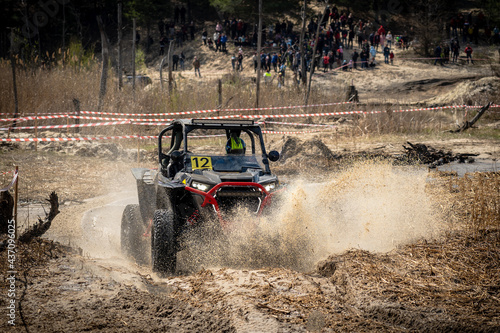 Offroad vehicle in the action and makes splashes of dirty water © Anton Tolmachov