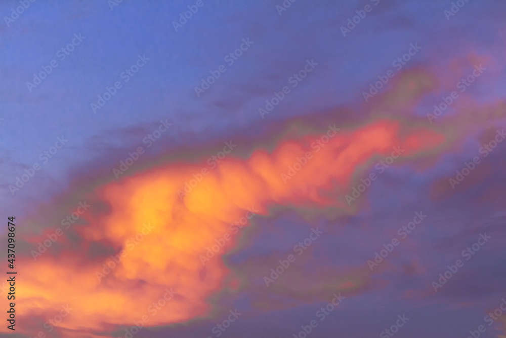 Colorful dramatic sky at sunset with layered rain clouds late at night