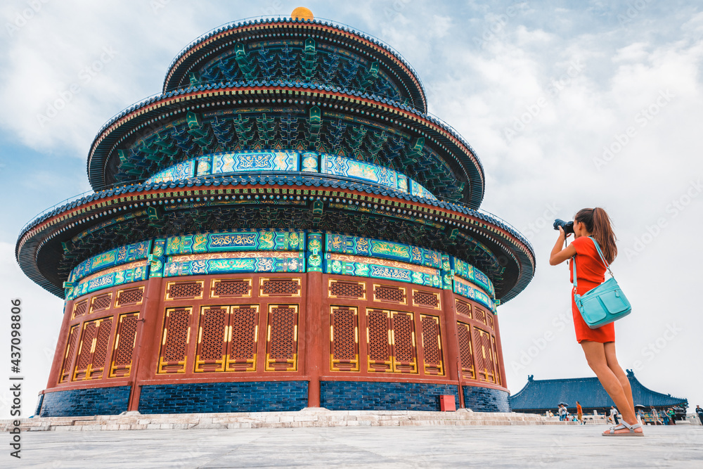 China travel tourist woman on vacation in Beijing taking pictures with camera of worship temple of Heaven. Asia vacation destination. Young traveler world adventure.