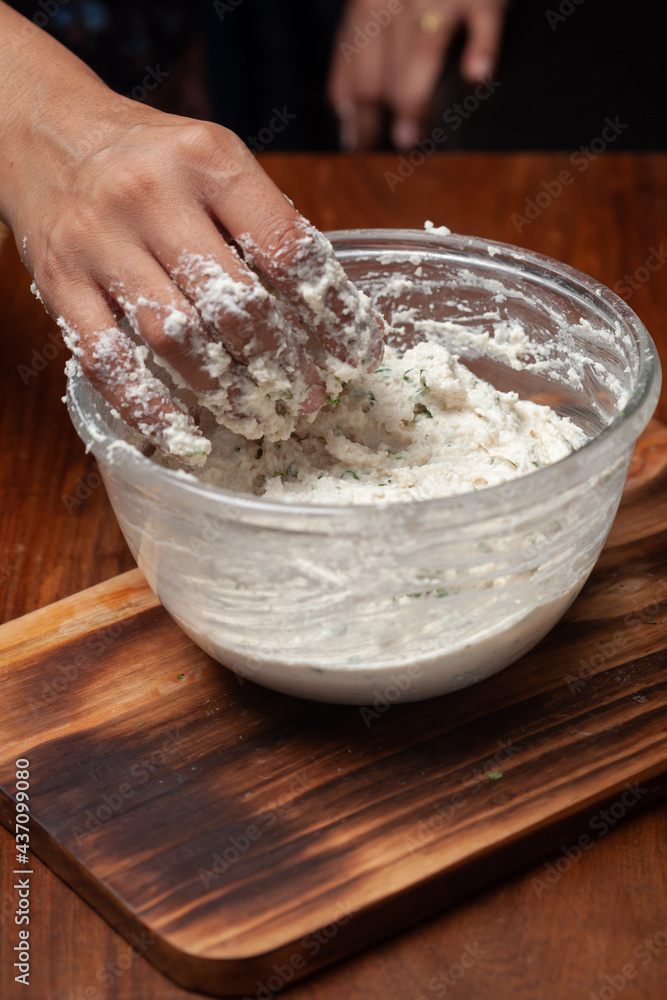 Fototapeta premium Close-up of Preparation of dahi vada - mixture of grind urad dal with condiments and ingredients and roasted cumin and green fresh coriander for preparation of chaat.