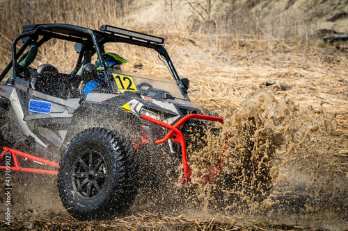 Active ATV and UTV Off-Road vehicle in muddy water. ATV 4x4