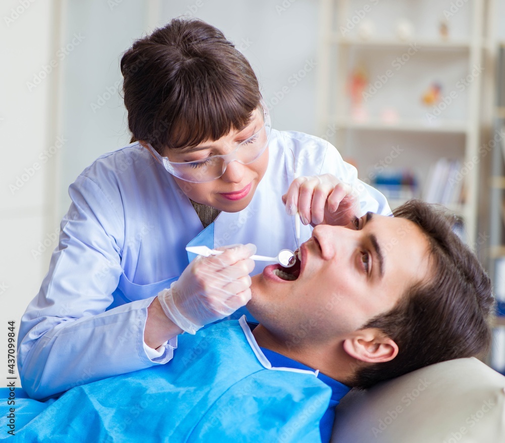 Woman dentist doctor with male patient in hospital Woman dentist doctor with male patient in hospital