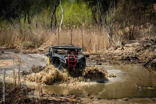 Fast ATV and UTV driving in mud and water. Quad racing, ATV 4x4.