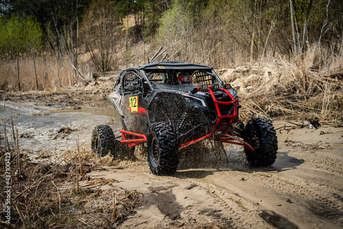 Offroad vehicle in the action and makes splashes of dirty water