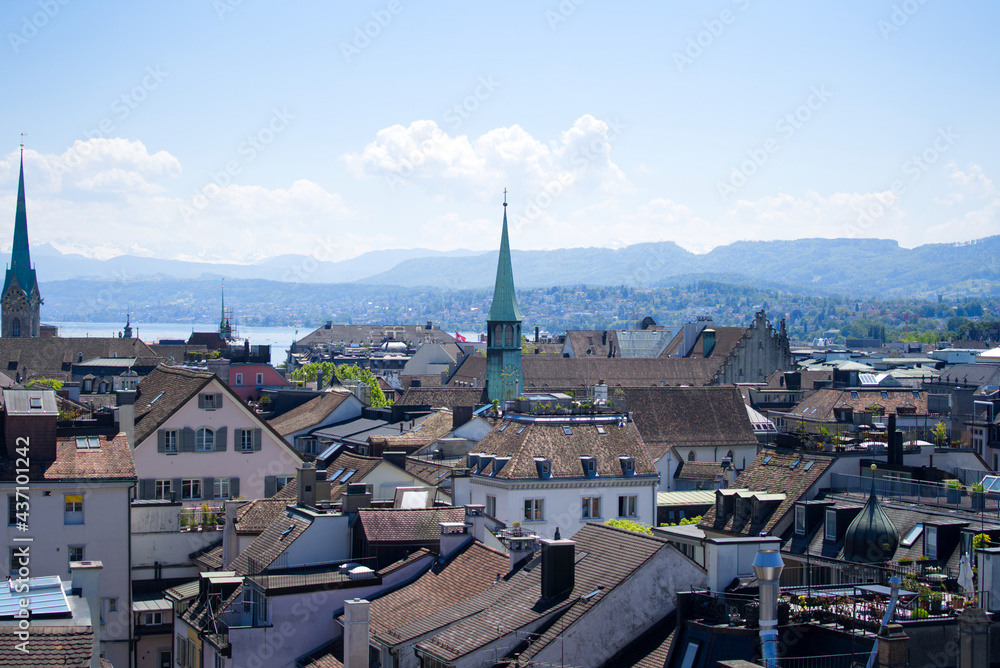 Old town of Zurich with churches and lake Zurich and Swiss alps in the background. Photo taken June 1st, 2021, Zurich, Switzerland.