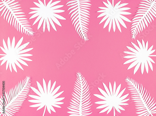 Tropical paper leaves on pink background, flat lay with copy space.
