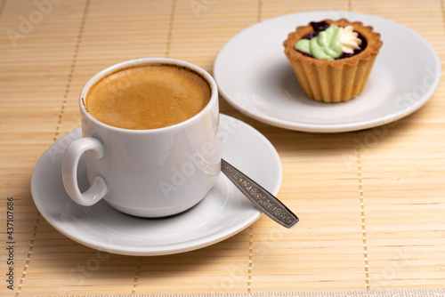 Morning aromatic coffee with cupcakes with cream cakes on a white plate. Selective Focus