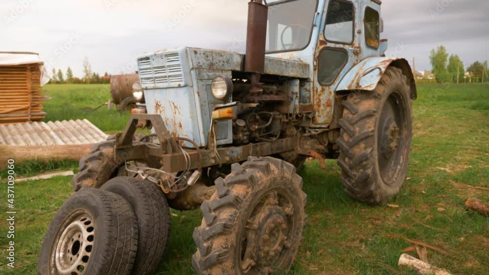 Close up shot of old rusty russian tractor. Residents of countryside. Tractor changing his color. Close up shot of old rusty russian tractor. Residents of countryside. Tractor changing his color.