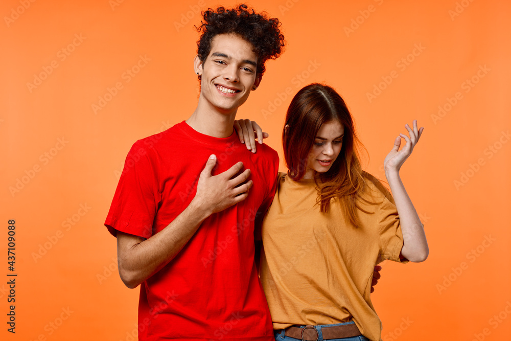 Fototapeta premium funny guy and girl in multicolored t-shirts modern style fashion