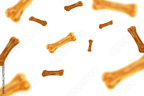 Flying falling dog food bones on white background, soft focus background
