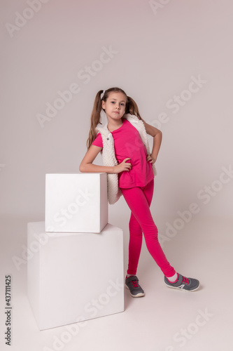 Active sports girl with pink clothes and sneakers on a white background