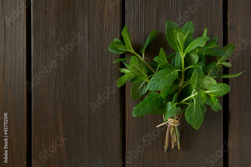bunch of mint leaves on wooden surface