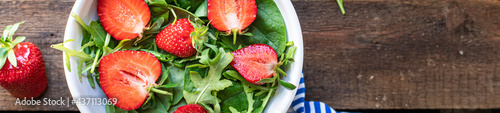 green salad strawberry leaves salad mix arugula, spinach organic healthy food meal snack copy space food background rustic. top view diet vegan or vegetarian food