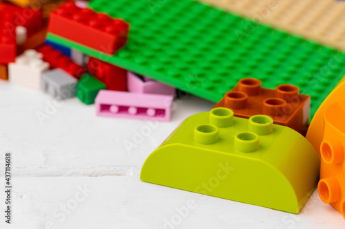 Toy building kit details on wooden background