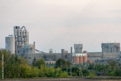 Factory chimneys against the gray autumn sky. Utopian landscape background. White toxic smoke is coming from a huge pipe. Pollution of the environment and nature. The collapse of civilization.